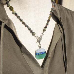 Turquoise green pendant and necklace on model